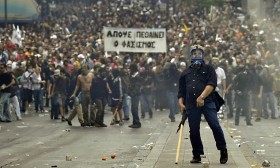 A protestor gestures to police near the