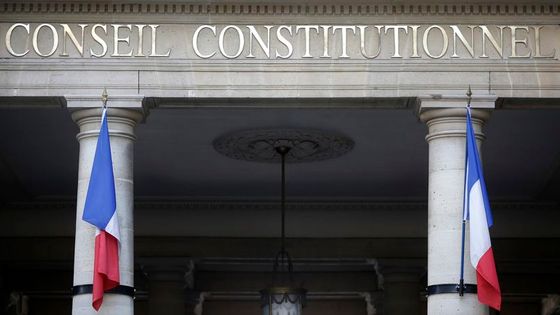 French flags hang outside the entrance of the Constitutional Council in Paris