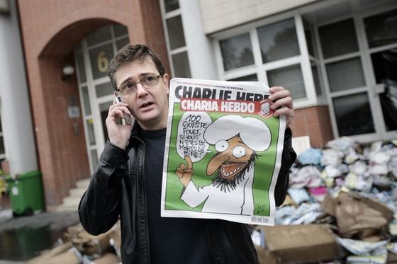 Stéphane Charbonnier, Charlie Hebdo, murdered on January 7 along with many of his colleagues, is shown here in front of the magazine's former offices, just after they were firebombed in November 2011.