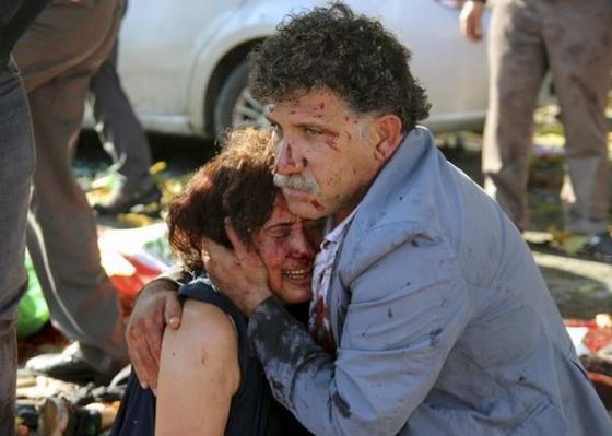 An injured man hugs an injured woman after an explosion during a peace march in Ankara, Turkey, October 10, 2015. REUTERS/Tumay Berkin