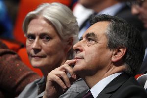 FILE PHOTO - French politician Francois Fillon, member of the conservative Les Republicains political party and his wife Penelope (L) attend a final rally ahead of the first round of vote to choose the conservative candidate for France's presidential election in Paris, France, November 18, 2016. French presidential election frontrunner Francois Fillon said on January 25, 2017 that he was outraged at a press report that his wife had been paid for fake work and said the article showed "contempt and misogyny".  Picture taken November 18, 2016.   REUTERS/Charles Platiau/File Photo